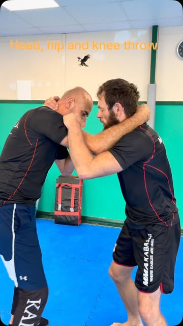 Two MMA Kabashi coaches demonstrating head, hip and knee throw technique