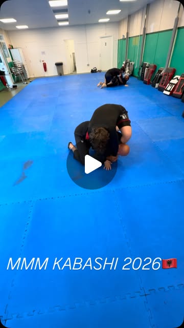 MMA Kabashi students practising grappling drills on blue training mats