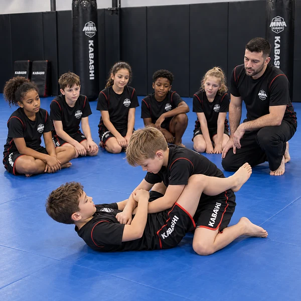Experienced instructor supervising controlled martial-arts training