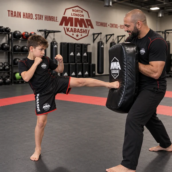 Young martial artist developing range and striking accuracy on a shield